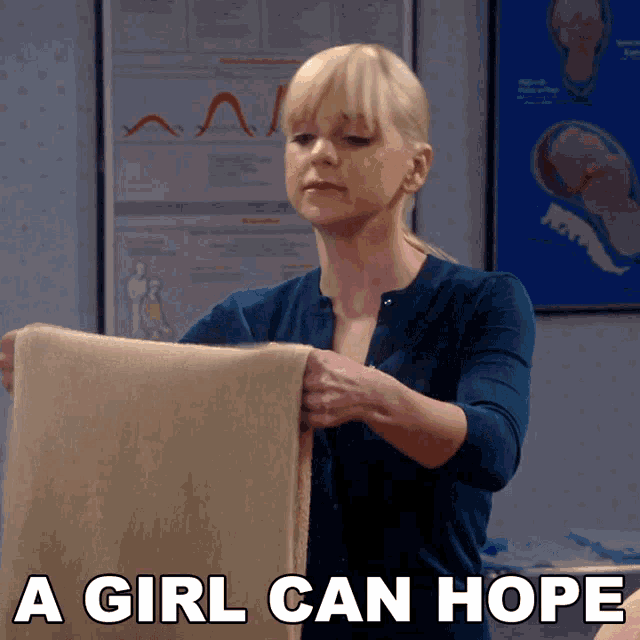 a woman is holding a blanket with the words a girl can hope below her
