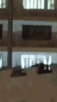 a blurry picture of a room with a statue in the middle of it