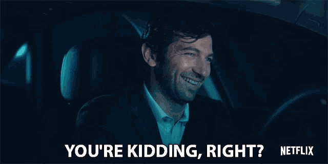 a man in a suit is driving a car and says " you 're kidding right netflix "