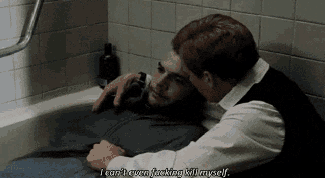 two men are hugging each other in a bathtub while one of them says i can 't even fucking kill myself .