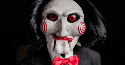 a puppet wearing a mask and a red bow tie