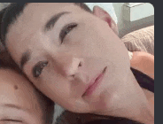 a close up of a woman 's face with a man 's head on her chest .