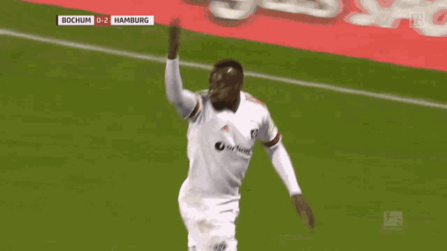 a soccer player celebrates a goal against hamburg