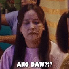 a woman in a purple shirt says ano daw??