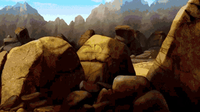 a pile of rocks in a desert with mountains in the background