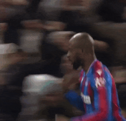 a soccer player with the number 14 on his jersey is jumping in the air