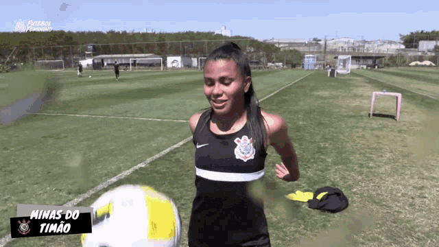 a female soccer player named minas do timao holds a soccer ball