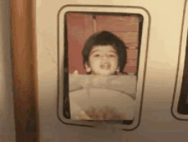 a picture of a young boy in a frame with his mouth open