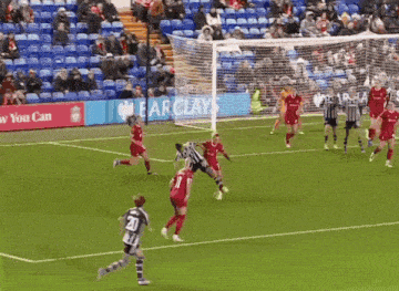 a soccer game with a barclays banner behind the goal