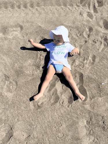 a baby wearing a shirt that says grow and flow