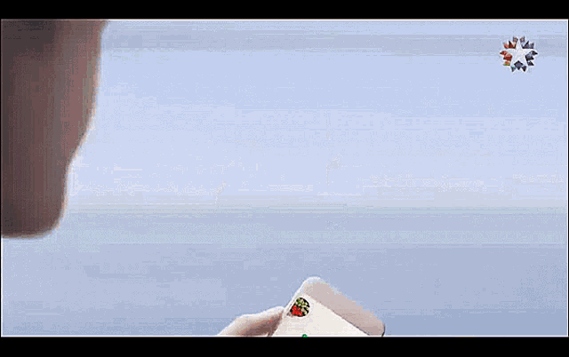 a person is holding a cell phone with a green c on the screen