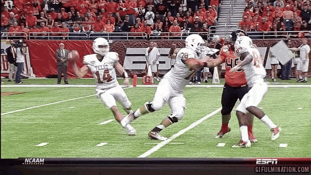 a football game is being played in front of a ncaam logo