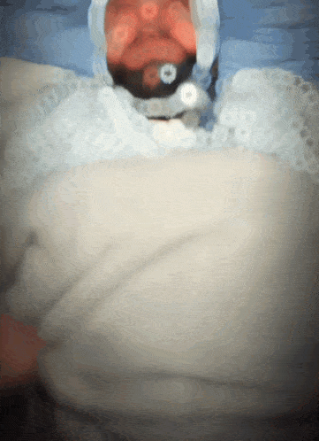 a blurred image of a person in a white blanket