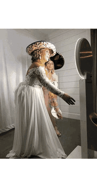 a woman in a wedding dress is posing for a picture