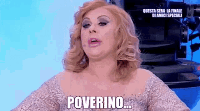 a woman in a silver dress says " poverino "