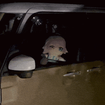 a stuffed doll in the driver 's seat of a car