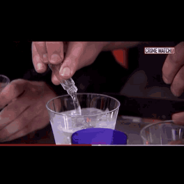 a woman drinking from a cup with the words crime watch on the screen