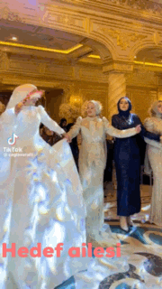 a group of women are dancing in a room with the words hedef ailesi written on the bottom