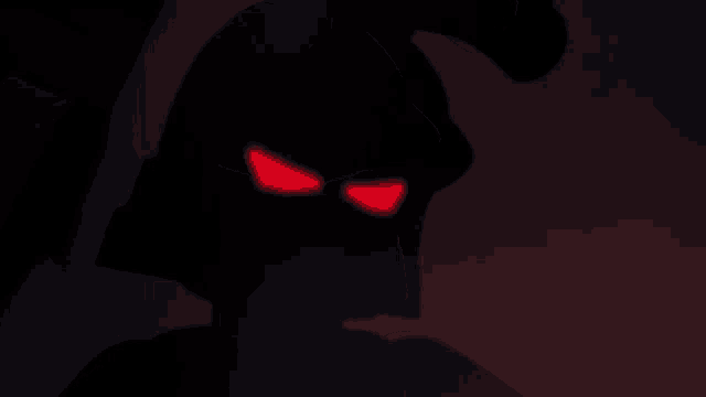 a cartoon character with red eyes is standing in the dark .