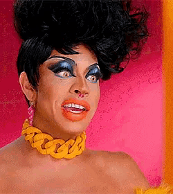 a drag queen wearing a yellow chain necklace