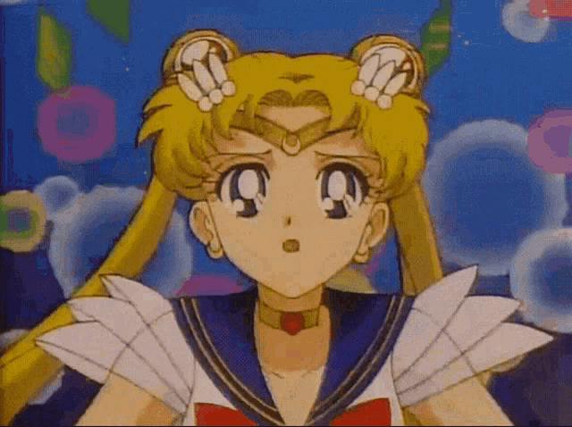 a close up of a sailor moon anime character