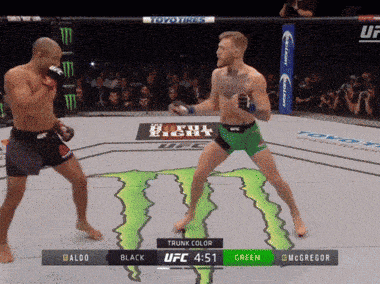 two men are fighting in a ufc ring with a monster energy drink logo in the background