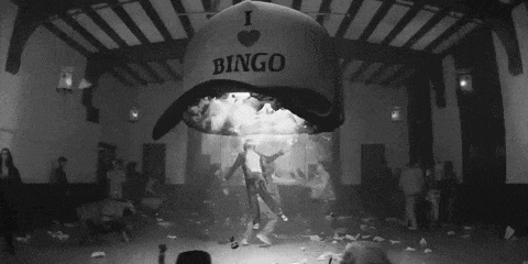 a black and white photo of people in a room with a sign that says bingo