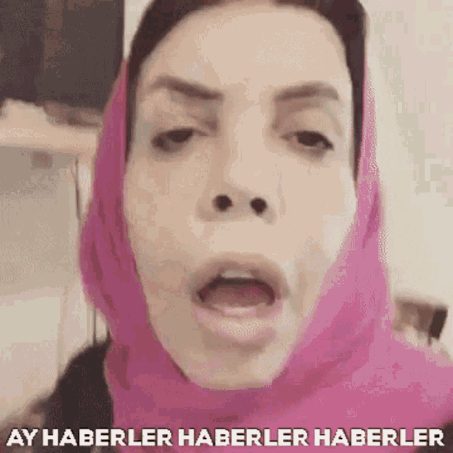 a woman wearing a pink head scarf says ay haberler