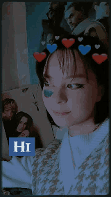 a girl with hearts on her head and a blue sticker that says hi on it