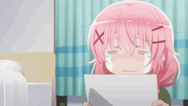 a girl with pink hair is holding a piece of paper in her hand