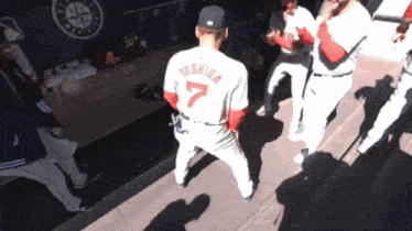 a baseball player with the number 7 on the back of his jersey