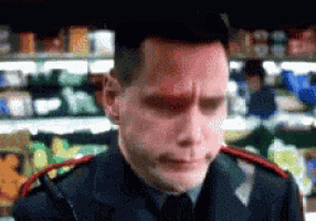 a man in a uniform with a red spot on his forehead stands in front of a grocery store shelf