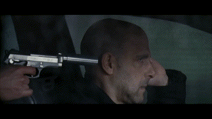 a close up of a man 's face in a rear view mirror