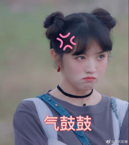 a girl with chinese writing on her face makes a funny face