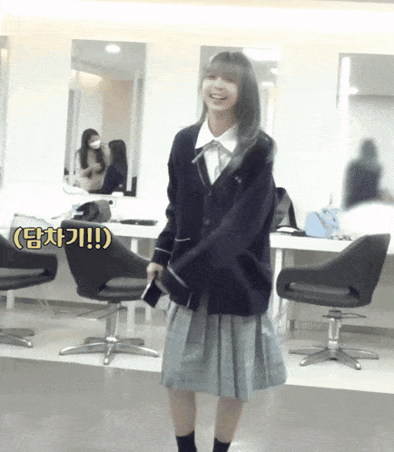 a girl in a school uniform is standing in a room with chairs and a sign that says ' !! ' on it