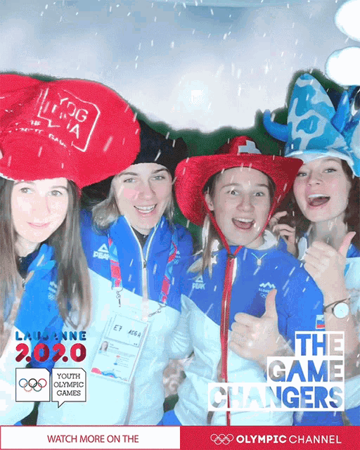 a group of young women are posing for a photo with the olympic channel advertisement in the background