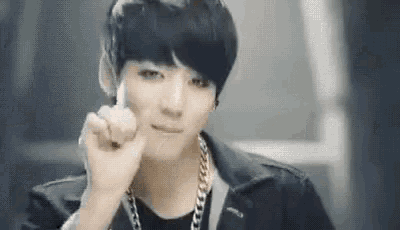 a young man is giving a middle finger .