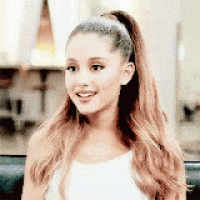 ariana grande is wearing a ponytail and a white tank top .