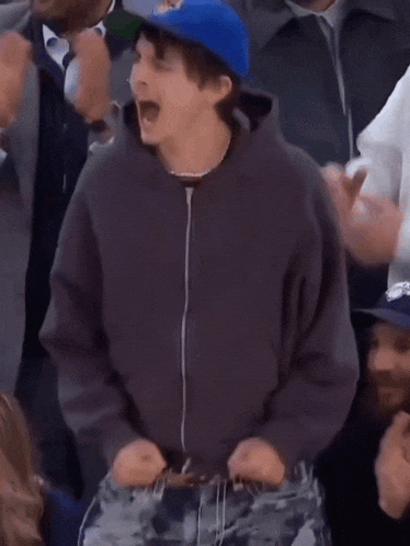 a man wearing a blue hat that says oklahoma on it