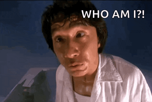 a man in a white shirt is asking the question who am i .