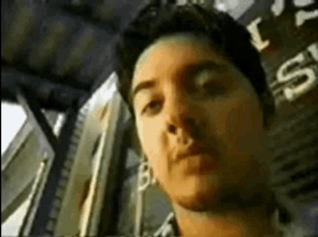 a close up of a man 's face with a sign in the background that says ' i 'm sorry '