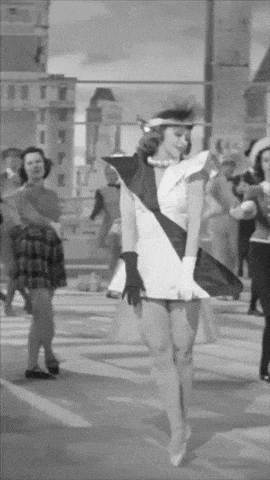 a black and white photo of a woman in a short dress