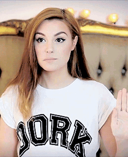a woman wearing a white t-shirt that says york on it