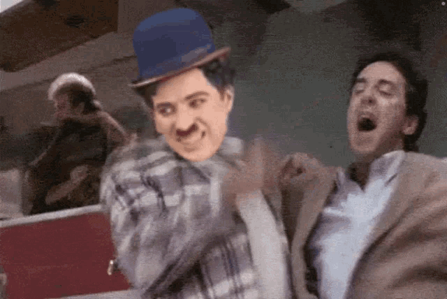 a man wearing a blue hat is dancing with another man
