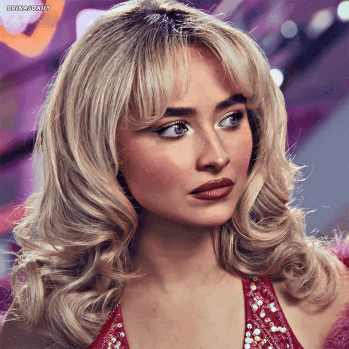a woman with blonde hair and a red dress has the hashtag brinasdaily at the bottom