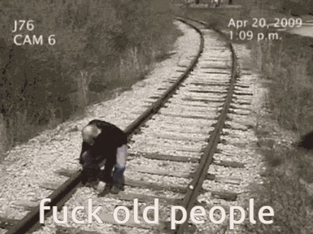 a black and white photo of train tracks with the words fuck old people