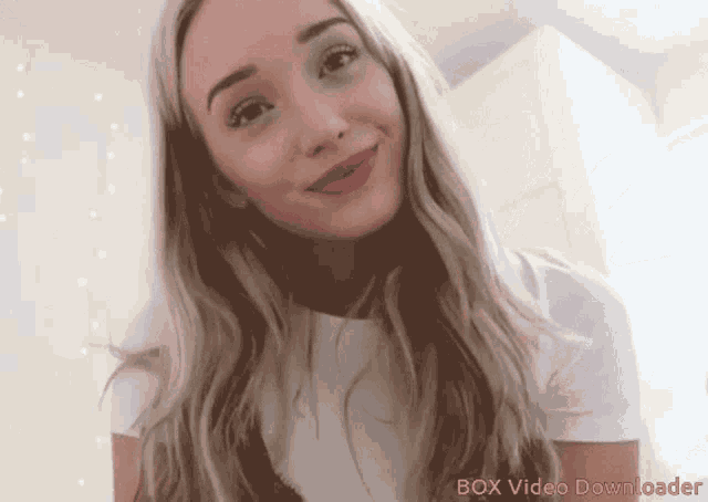 a woman 's face is shown with the words box video downloader below her