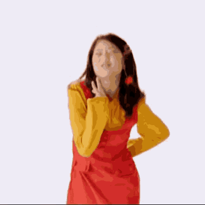 a woman in a red dress and a yellow shirt is dancing .