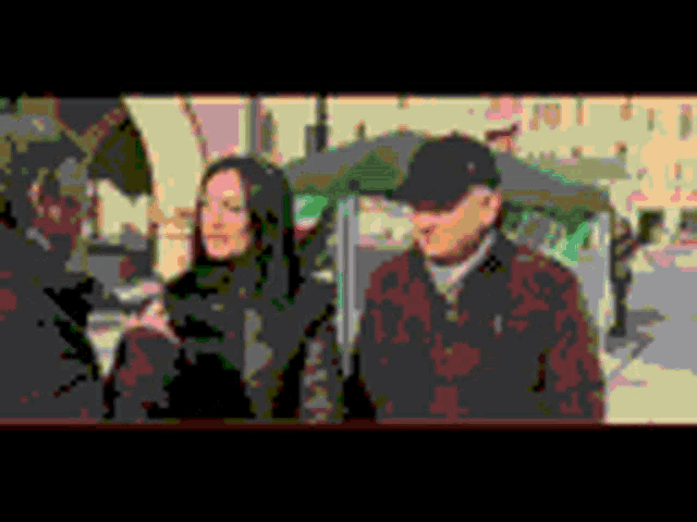 a man and a woman are standing under an umbrella in a pixelated image