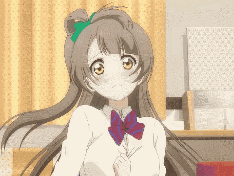 a girl with long brown hair and a red and blue bow tie